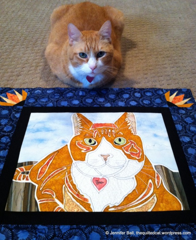 Tiger inspects his quilt