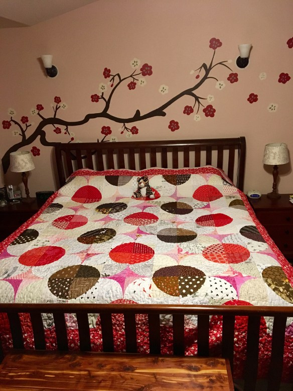 Cherry Blossom quilt on a king-size bed
